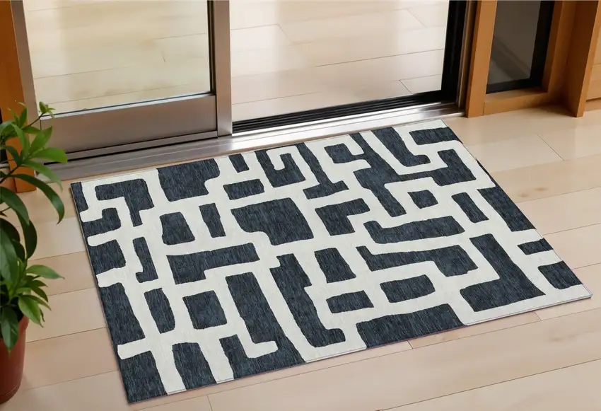 Black And Ivory Abstract Washable Indoor Outdoor Area Rug Photo 1