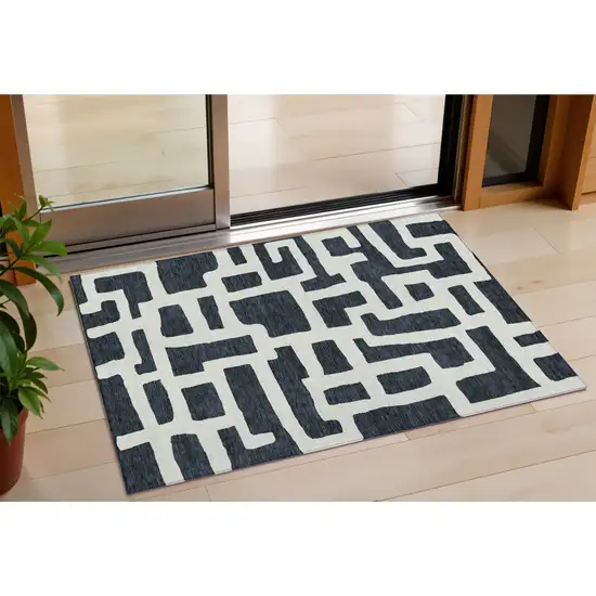 Black And Ivory Abstract Washable Indoor Outdoor Area Rug Photo 1