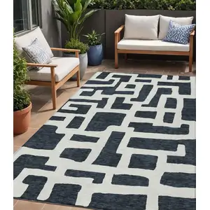 Photo of Black And Ivory Abstract Washable Indoor Outdoor Area Rug
