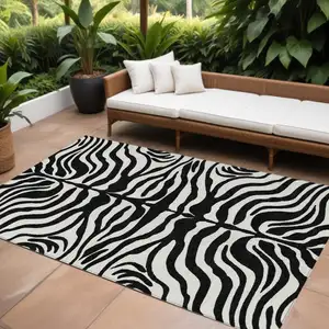 Photo of Black And Ivory Animal Print Washable Indoor Outdoor Area Rug
