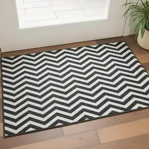 Photo of Black And Ivory Chevron Washable Area Rug With UV Protection