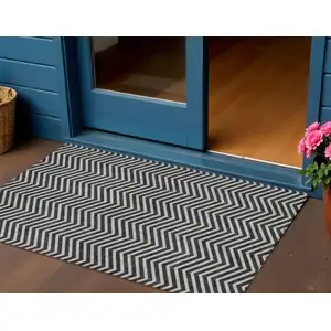 Photo of Black And Ivory Chevron Washable Indoor Outdoor Area Rug