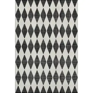 Photo of Black And Ivory Diamond Washable Area Rug With UV Protection