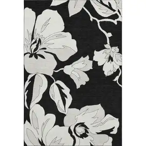 Photo of Black And Ivory Floral Washable Area Rug With UV Protection