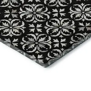 Photo of Black And Ivory Floral Washable Area Rug With UV Protection