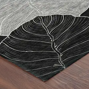 Photo of Black And Ivory Floral Washable Indoor Outdoor Area Rug