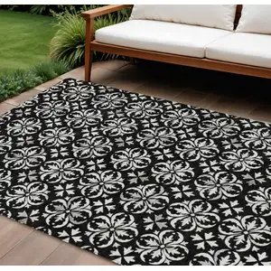Photo of Black And Ivory Floral Washable Indoor Outdoor Area Rug