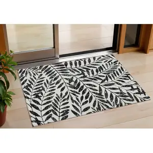 Photo of Black And Ivory Floral Washable Indoor Outdoor Area Rug