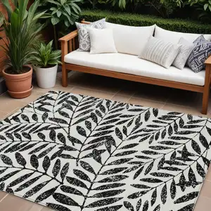Photo of Black And Ivory Floral Washable Indoor Outdoor Area Rug