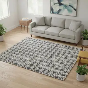 Photo of Black And Ivory Geometric Washable Area Rug With UV Protection