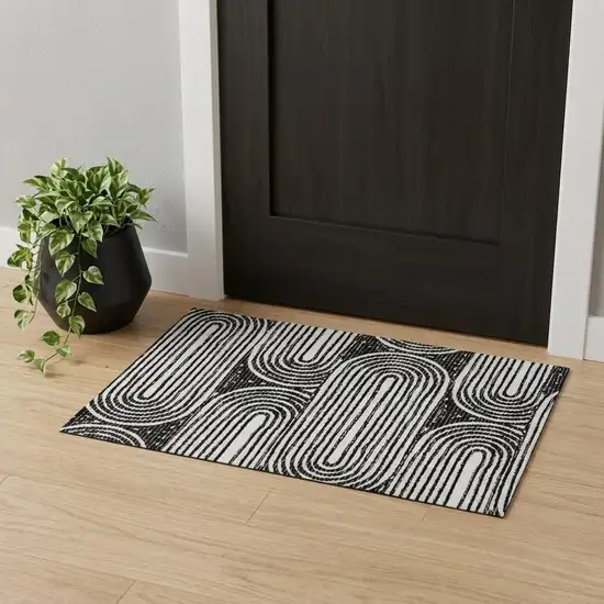 Black And Ivory Geometric Distressed Washable Area Rug With UV Protection Photo 1