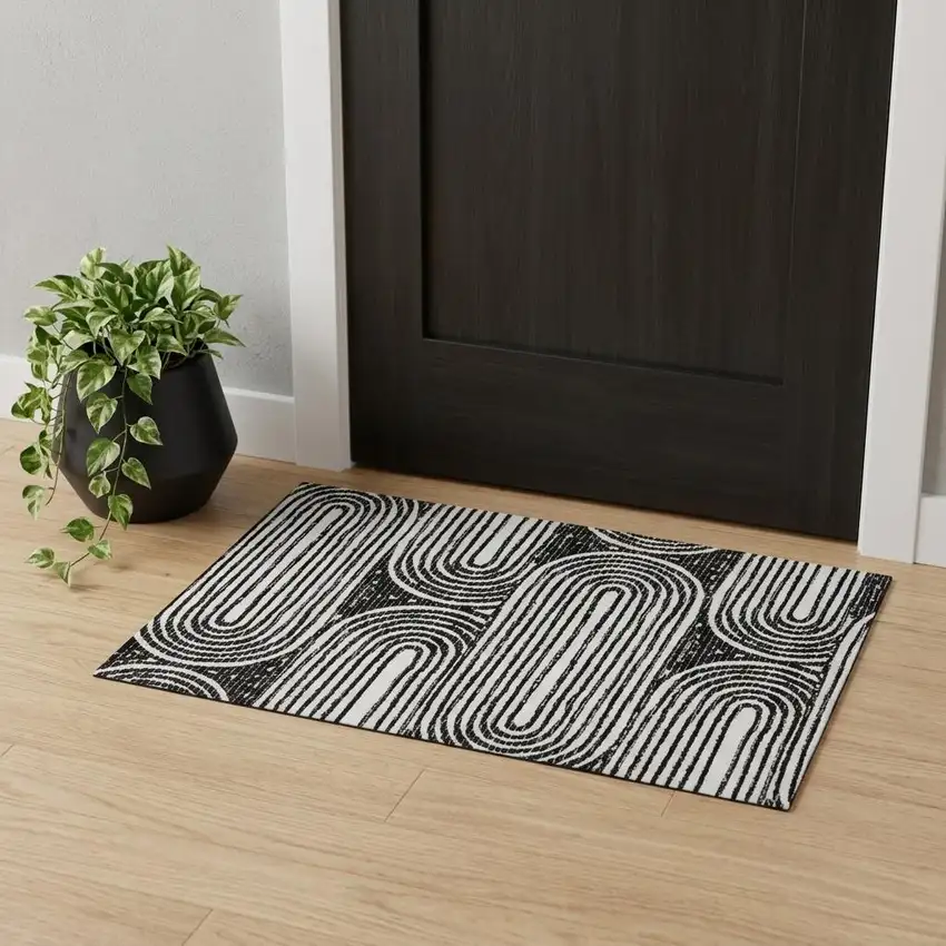 Black And Ivory Geometric Distressed Washable Area Rug With UV Protection Photo 1