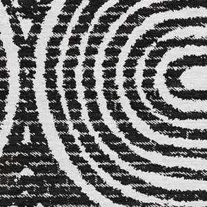 Photo of Black And Ivory Geometric Washable Area Rug With UV Protection