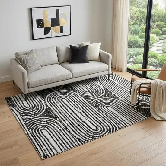 Black And Ivory Geometric Distressed Washable Area Rug With UV Protection Photo 1