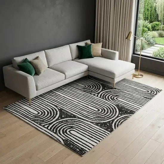 Black And Ivory Geometric Distressed Washable Area Rug With UV Protection Photo 1