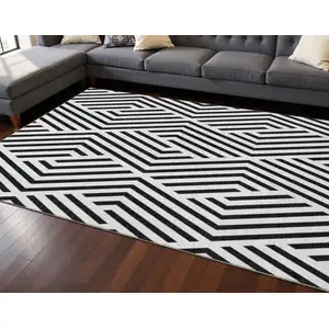 Photo of Black And Ivory Geometric Washable Area Rug With UV Protection