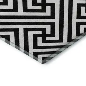 Photo of Black And Ivory Geometric Washable Area Rug With UV Protection