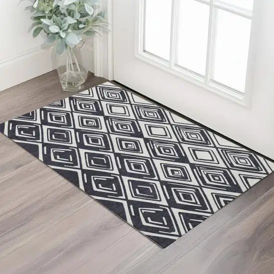 Black And Ivory Geometric Washable Area Rug With UV Protection Photo 1