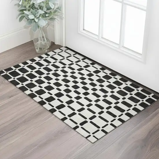 Black And Ivory Geometric Washable Area Rug With UV Protection Photo 1