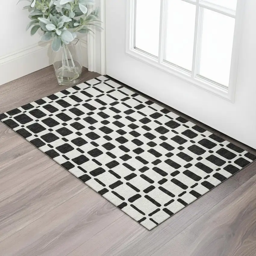Black And Ivory Geometric Washable Area Rug With UV Protection Photo 1
