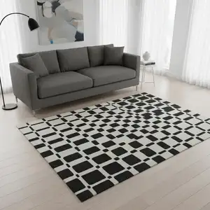 Photo of Black And Ivory Geometric Washable Area Rug With UV Protection