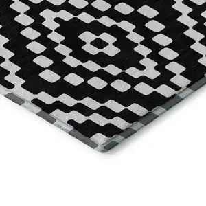 Photo of Black And Ivory Geometric Washable Area Rug With UV Protection