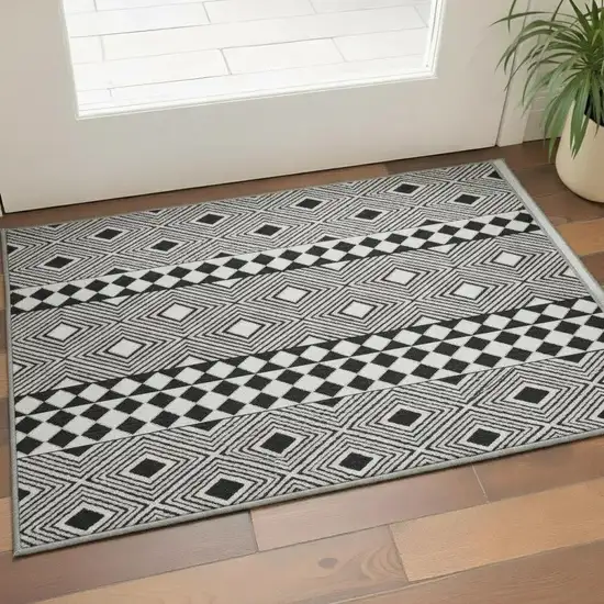 Black And Ivory Geometric Washable Area Rug With UV Protection Photo 2