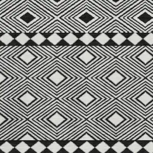 Photo of Black And Ivory Geometric Washable Area Rug With UV Protection