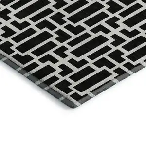 Photo of Black And Ivory Geometric Washable Area Rug With UV Protection