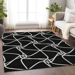 Photo of Black And Ivory Geometric Washable Area Rug With UV Protection
