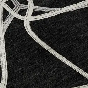 Photo of Black And Ivory Geometric Washable Area Rug With UV Protection