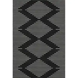 Photo of Black And Ivory Geometric Washable Area Rug With UV Protection