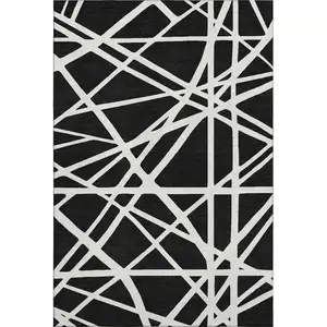 Photo of Black And Ivory Geometric Washable Area Rug With UV Protection