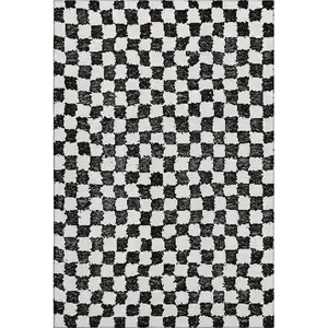 Photo of Black And Ivory Geometric Washable Area Rug With UV Protection