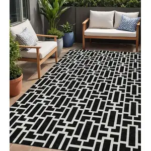 Photo of Black And Ivory Geometric Washable Indoor Outdoor Area Rug