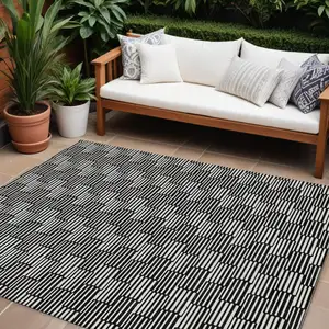 Photo of Black And Ivory Geometric Washable Indoor Outdoor Area Rug