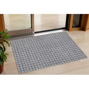 Photo of Black And Ivory Geometric Washable Indoor Outdoor Area Rug