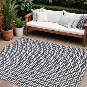 Photo of Black And Ivory Geometric Washable Indoor Outdoor Area Rug