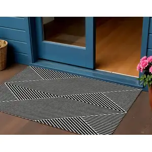 Photo of Black And Ivory Geometric Washable Indoor Outdoor Area Rug