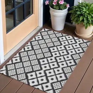 Photo of Black And Ivory Geometric Washable Indoor Outdoor Area Rug