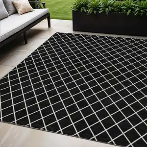 Photo of Black And Ivory Geometric Washable Indoor Outdoor Area Rug