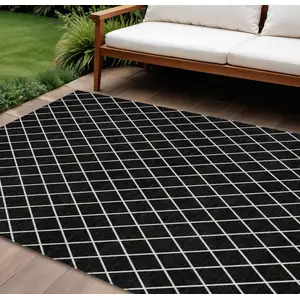 Photo of Black And Ivory Geometric Washable Indoor Outdoor Area Rug