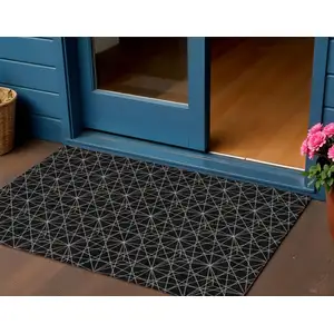 Photo of Black And Ivory Geometric Washable Indoor Outdoor Area Rug