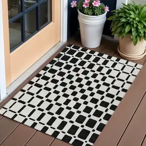 Photo of Black And Ivory Geometric Washable Indoor Outdoor Area Rug
