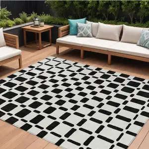 Photo of Black And Ivory Geometric Washable Indoor Outdoor Area Rug
