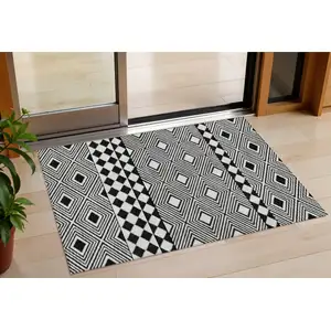 Photo of Black And Ivory Geometric Washable Indoor Outdoor Area Rug