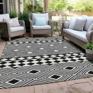 Photo of Black And Ivory Geometric Washable Indoor Outdoor Area Rug