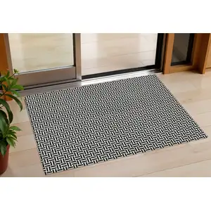 Photo of Black And Ivory Geometric Washable Indoor Outdoor Area Rug