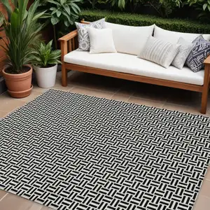Photo of Black And Ivory Geometric Washable Indoor Outdoor Area Rug