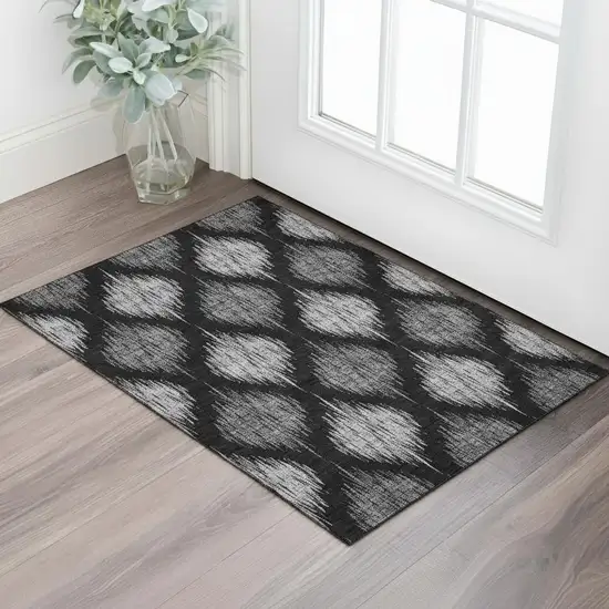Black And Ivory Ikat Washable Area Rug With UV Protection Photo 1